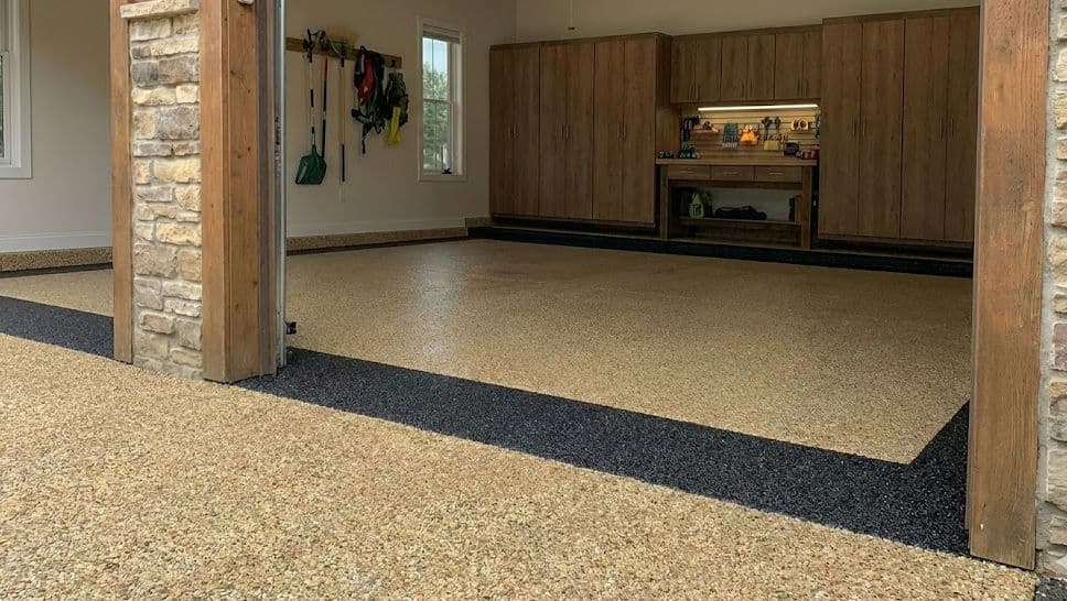 Spacious garage interior featuring epoxy flooring and organized storage solutions.